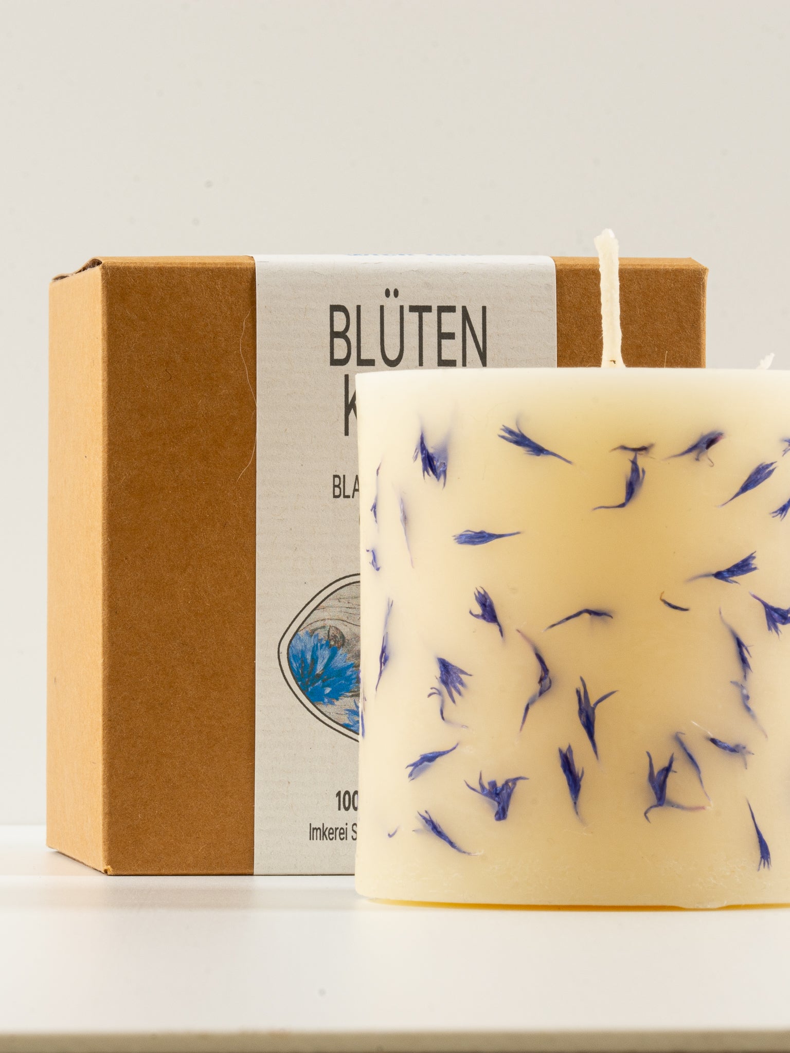 Blütenkerze aus Bienenwachs mit attraktiver Geschenkverpackung aus Karton.